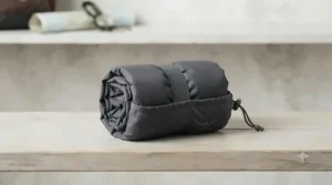 Packable rain pants folded into a compact storage pouch for easy travel.