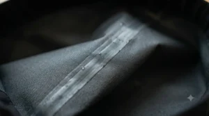 Graphic detail of heat-sealed seams on rain pants to prevent water leakage.