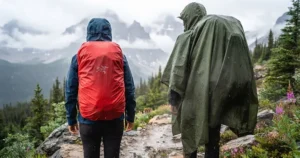 Illustration showing a full-length hiking poncho covering both the hiker and their backpack in a sudden downpour.