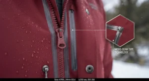 Close-up illustration highlighting durable zippers and taped seams on a high-performance winter shell jacket.