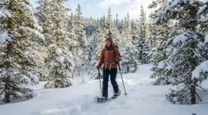 An outdoor enthusiast exploring a snow-covered pine forest wearing insulated winter boots for Canadian winters.