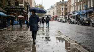 A commuter walking through city puddles wearing men's rain boots under $60 CAD during a rainy morning in Toronto.